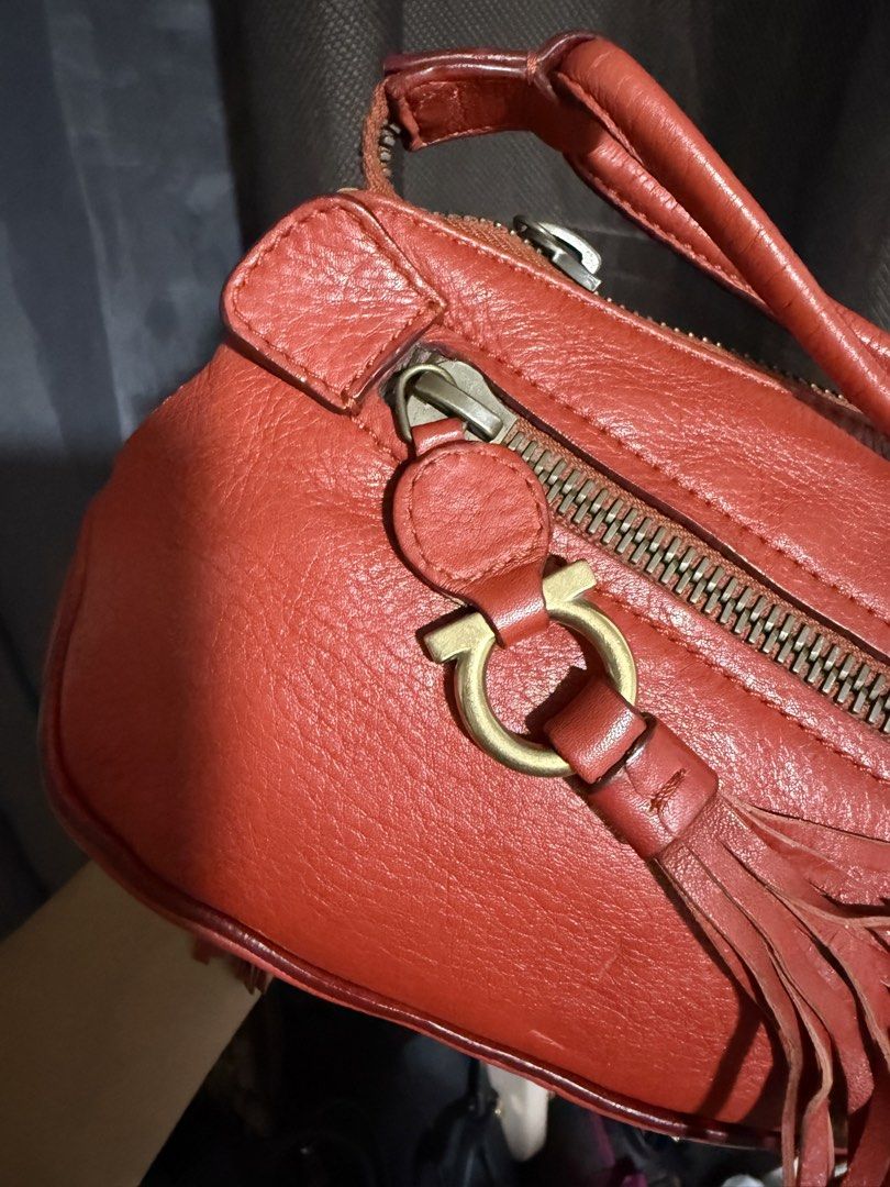 Salvatore Ferragamo Red Leather (Category: Luxury Bags & Wallets) located in Manila. Submitted by rubyjaneba27331 (Listing ID 1442274215, Image 3). Description: Iconic Gancini hardware and tassel detail Secure zipper closure With dust bag Loc: upper Antipolo.