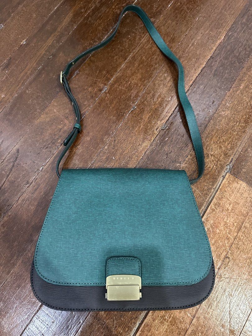 Sisley Shoulder Bag - Teal and Dark Grey (Category: Shoulder Bags) located in Del Monte. Submitted by bittersweetcigs (Listing ID 1442279962, Image 1). Description: - Stylish teal and dark grey shoulder bag - Textured material for a unique look - Secure gold-tone buckle closure with 'Sisley' logo - Adjustable strap for comfortable carrying - Ideal for everyday use.