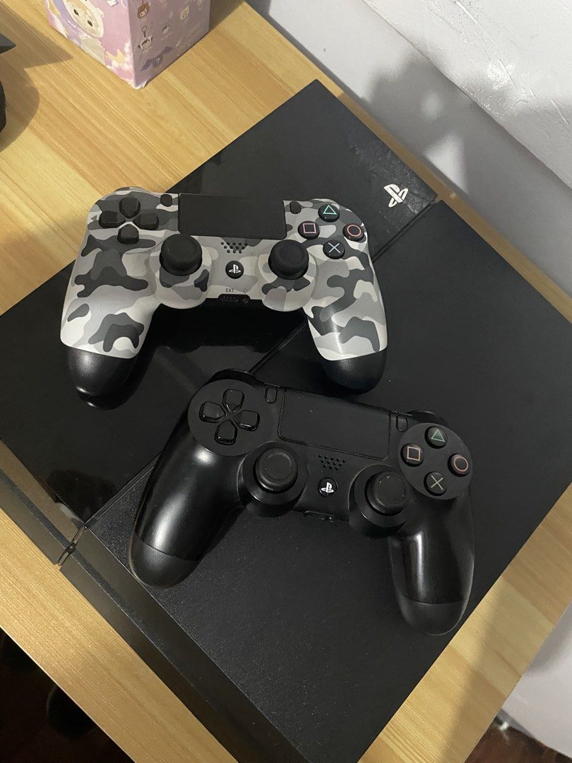 Sony PlayStation 4 Console Fat 1Tb (Category: PlayStation) located in Quezon City. Submitted by rnch444 (Listing ID 1442189171, Image 2). Description: - Black Sony PlayStation 4 console - Two DualShock 4 controllers (1 black, 1 grey camouflage) - Power cable included - Fat Model - 1 Terabyte - HDMI not included dm for more.