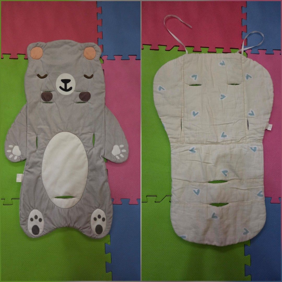 Stroller Pad Baby Cushion (2pcs) (Category: Strollers) located in Davao. Submitted by noona.nette (Listing ID 1442211492, Image 1). Description: - Adorable grey bear shaped stroller liner - Soft and padded for maximum baby comfort - Features cutouts for stroller harness safety - Reversible design: one side bear print, other side plain with blue heart pattern - Easy to attach with secure straps - Perfect for keeping your stroller clean and adding 