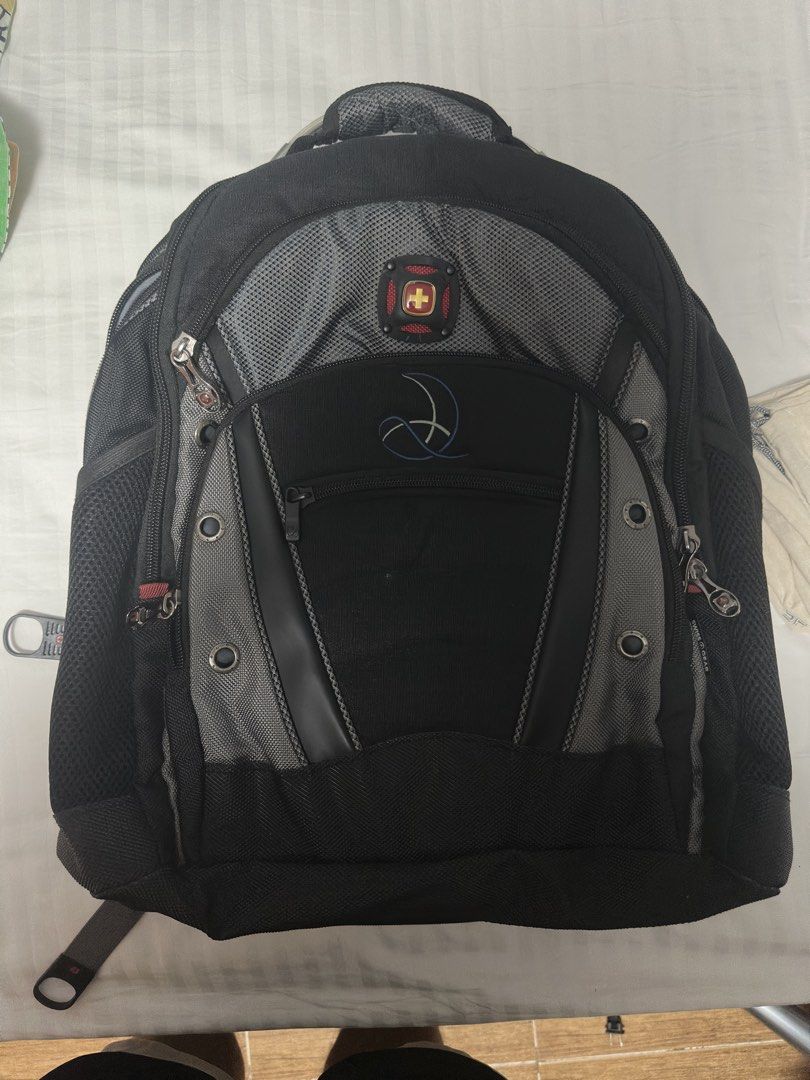 Swiss Gear Backpack Black Grey Laptop Bag (Category: Backpacks) located in Manila. Submitted by frzy009 (Listing ID 1442339722, Image 3). Description: Authentic SwissGear Heavy-Duty Laptop Backpack This is a special edition variant of their famous heavy-duty tech line (similar layout to the Ibex/1900 series), featuring a premium embroidered design on the front pocket. ✨ KEY FEATURES: Massive Capacity: Fits up to large 17-inch laptops in a dedicat