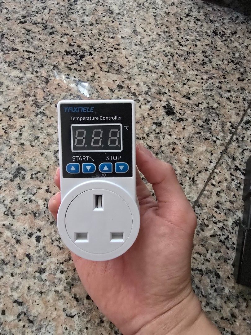 Temperature Controller Plug (Category: Electrical, Adaptors & Sockets) located in Singapore. Submitted by -sssss- (Listing ID 1442194568, Image 1). Description: Digital temperature controller with a UK plug. Set your desired temperature and it will maintain it. Great for incubators, terrariums, or heating/cooling setups. Easy to use with start and stop buttons. Shows current temperature on the display. Max load 10A/2200W. Temp range 0-120°C..