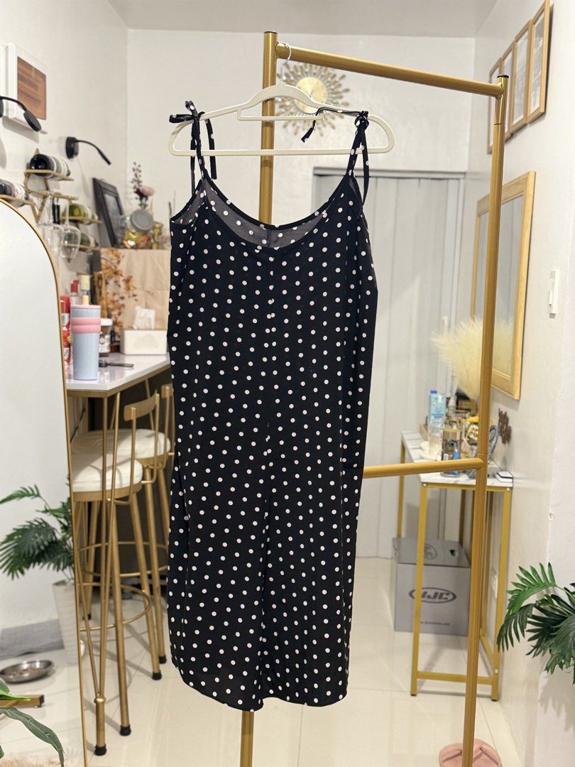 Trendy Polka Dot Spaghetti Strap Dress (Category: Dresses) located in Caloocan City. Submitted by zclothing_26 (Listing ID 1439052860, Image 1). Description: - Black midi dress with white polka dots - Adjustable spaghetti straps - Button-down front - Lightweight fabric - Suitable for warm weather.