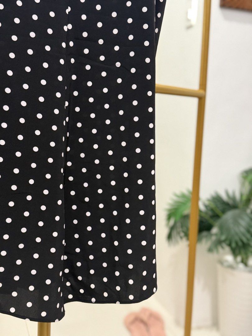 Trendy Polka Dot Spaghetti Strap Dress (Category: Dresses) located in Caloocan City. Submitted by zclothing_26 (Listing ID 1439052860, Image 2). Description: - Black midi dress with white polka dots - Adjustable spaghetti straps - Button-down front - Lightweight fabric - Suitable for warm weather.