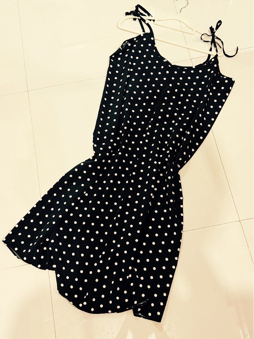 Trendy Polka Dot Spaghetti Strap Dress (Category: Dresses) located in Caloocan City. Submitted by zclothing_26 (Listing ID 1439052860, Image 3). Description: - Black midi dress with white polka dots - Adjustable spaghetti straps - Button-down front - Lightweight fabric - Suitable for warm weather.