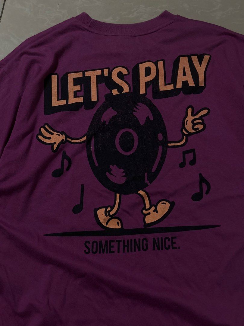 Vintage graphic purple shirt (Category: Tshirts & Polo Shirts ) located in Santa Rosa. Submitted by mandeclutterzzz (Listing ID 1442262549, Image 3). Description: Dimes: Width:20 inches Length:27 inches - Eye-catching purple t-shirt - Fun graphic on the back: a record character dancing with musical notes - Text on back: "LET'S PLAY SOMETHING NICE" - Small "LET'S PLAY" detail on the front chest - Classic short sleeves and crew neck design - Ideal 