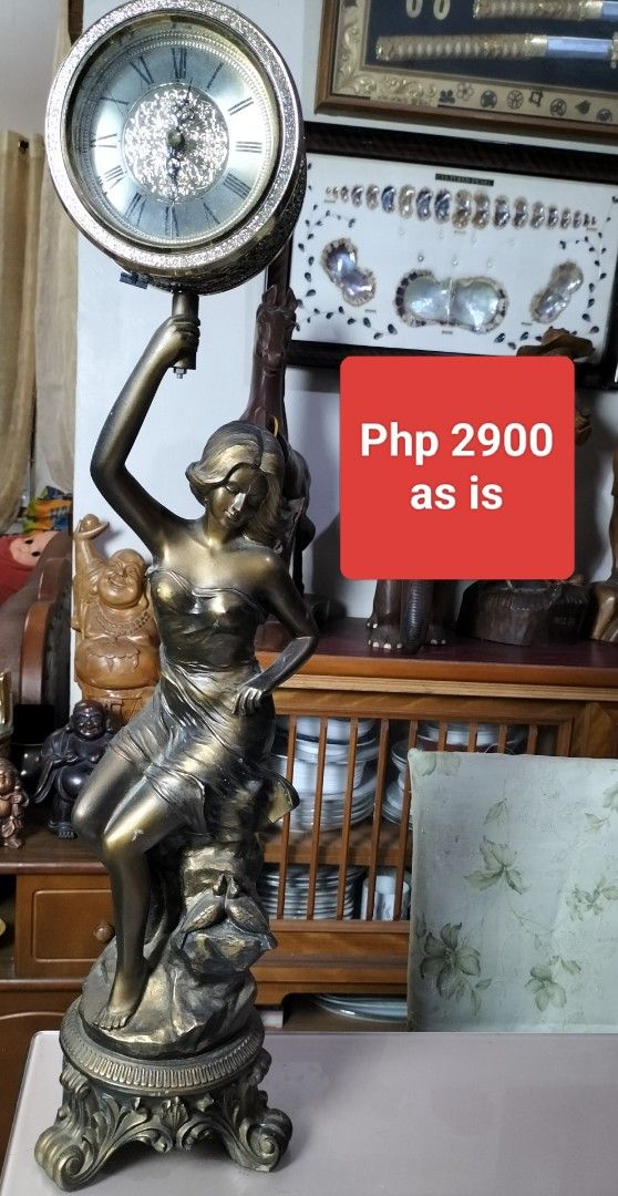 Vintage Woman Statue Desk Clock (Category: Clocks) located in Cainta. Submitted by banzvi73 (Listing ID 1442342452, Image 1). Description: - Elegant bronze-colored statue of a woman. - Features a decorative clock with Roman numerals. - Ideal for display on desks or shelves. - Sold in its current condition (as is). - Price: Php 2900..