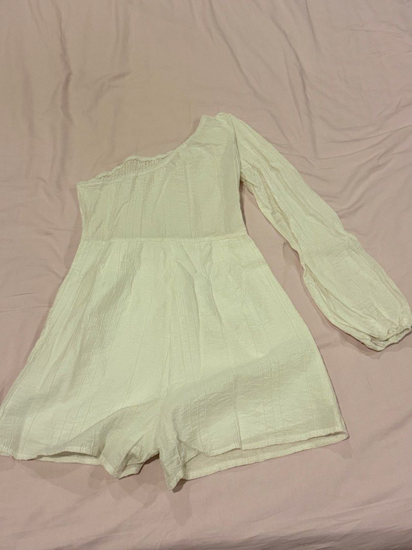 White One-Shoulder Smocked Romper with Puff Sleeve (Category: Rompers) located in Quezon City. Submitted by ellereve_ph (Listing ID 1442319774, Image 1). Description: - White one-shoulder romper - Smocked bodice for a comfortable fit - Features a stylish single puff sleeve - Textured fabric adds a unique touch - Convenient side zipper closure - Ideal for casual wear or beach trips.
