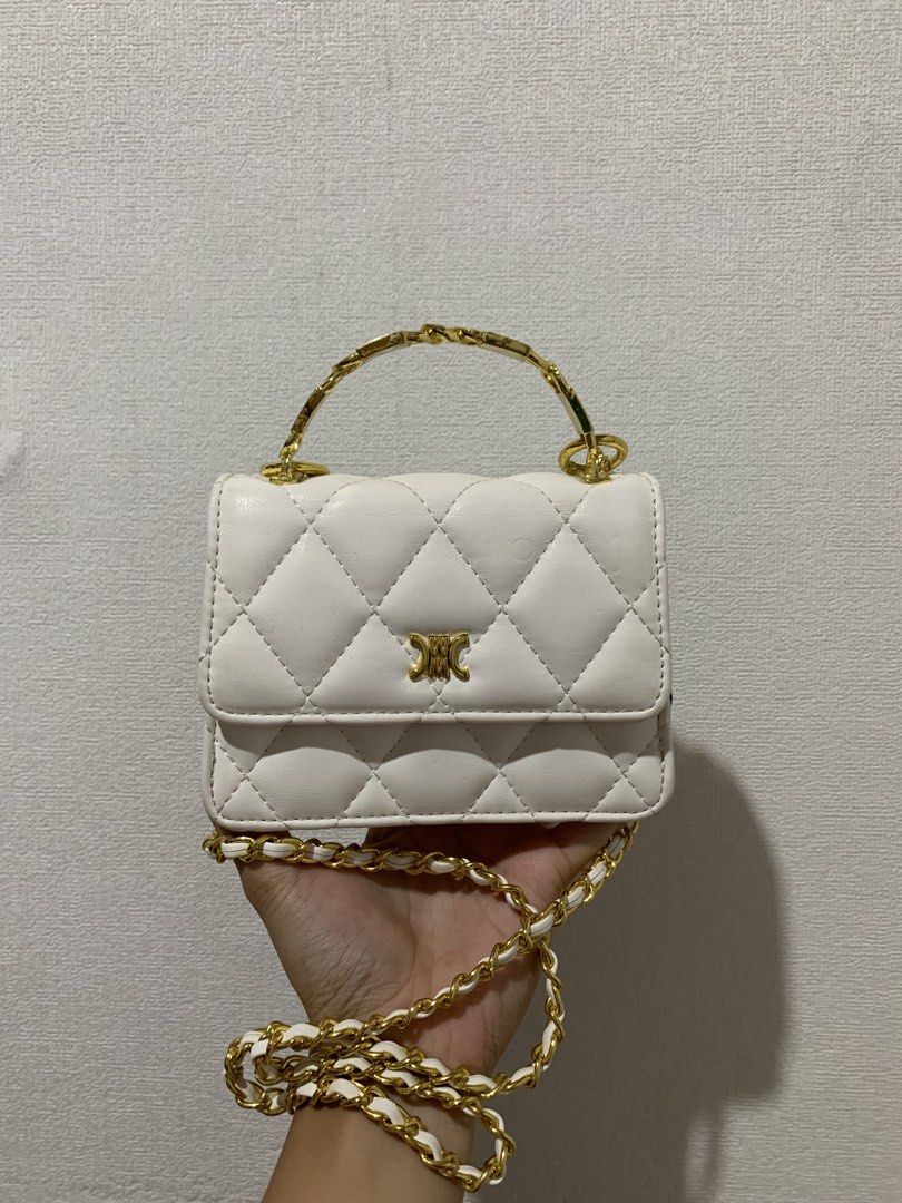 White Quilted Chain Bag with Gold Handle (Category: Luxury Bags & Wallets) located in Rizal. Submitted by pcesspscl145 (Listing ID 1442290286, Image 1). Description: - Adorable white quilted bag - Features a stylish gold chain strap - Unique gold handle for a touch of elegance - Includes a small inner compartment for organization - Compact size, perfect for carrying your essentials - Versatile for both going out and casual wear.