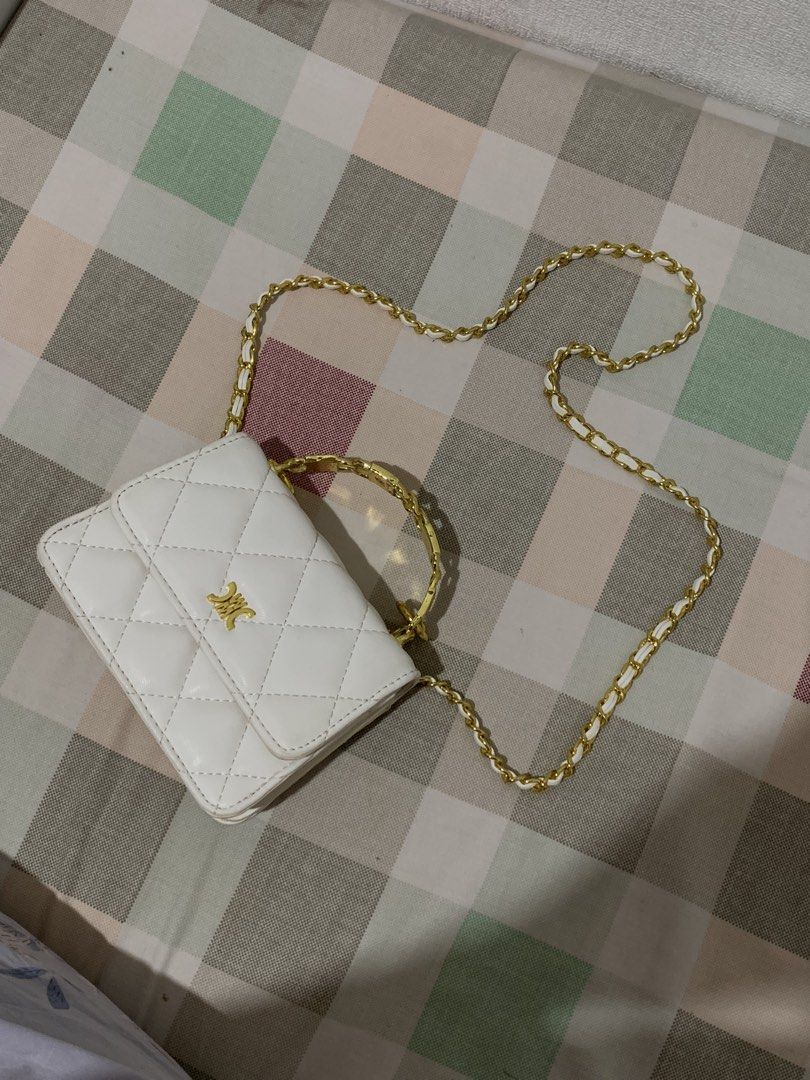 White Quilted Chain Bag with Gold Handle (Category: Luxury Bags & Wallets) located in Rizal. Submitted by pcesspscl145 (Listing ID 1442290286, Image 2). Description: - Adorable white quilted bag - Features a stylish gold chain strap - Unique gold handle for a touch of elegance - Includes a small inner compartment for organization - Compact size, perfect for carrying your essentials - Versatile for both going out and casual wear.