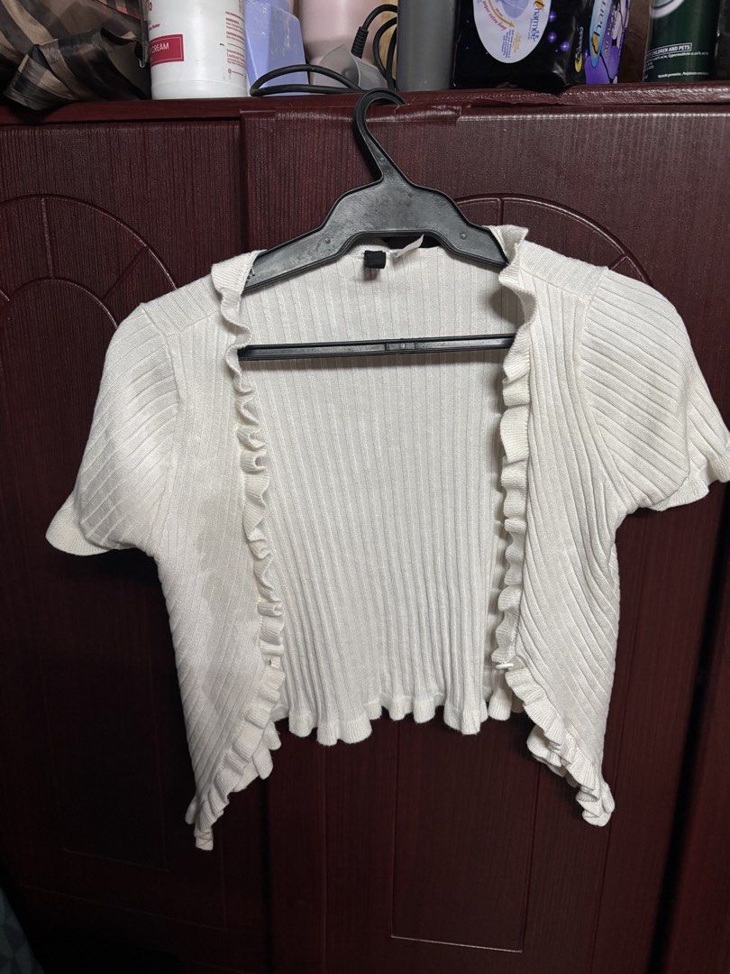 White Ribbed Ruffle Short Sleeve Cardigan (Category: Coats, Jackets and Outerwear) located in Makati City. Submitted by clutterfairie (Listing ID 1442291799, Image 1). Description: - Cute white cropped cardigan - Short sleeves - Ribbed texture - Ruffle detail on edges - Versatile for layering over tops or dresses - Adds a nice touch to any outfit.