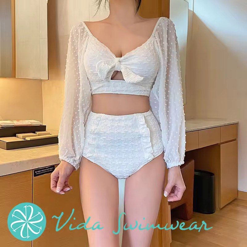 White Textured Bikini Set with Puff Sleeve Top (Category: Bikinis & Swimsuits) located in Manila. Submitted by yoongi17 (Listing ID 1442245532, Image 3). Description: - Adorable white bikini set - High-waisted bottoms with charming ruffles - Tie-front top with stylish puff sleeves - Sheer sleeves featuring a subtle dot pattern - Criss-cross tie detail at the back of the top - Bottoms still have the hygienic protection sticker attached - Perfect f