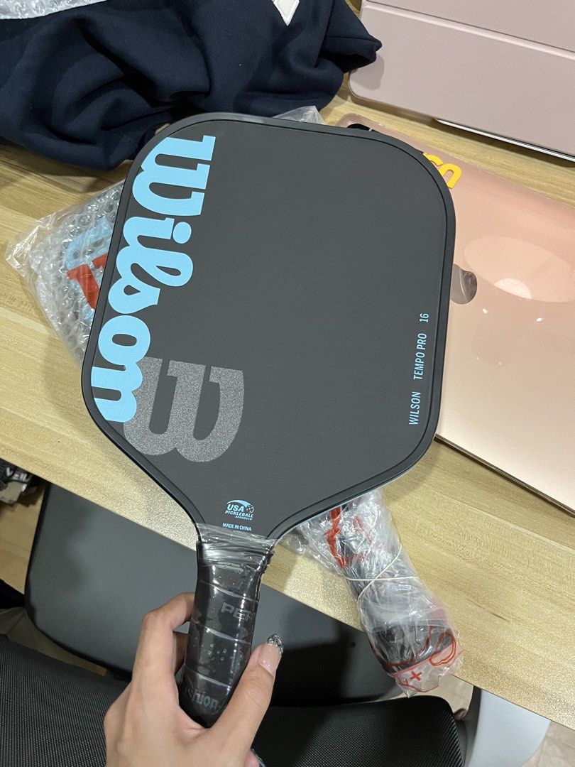 Wilson Tempo Pro 16 Pickleball Paddle (Category: Racket and Ball Sports) located in Caloocan City. Submitted by limerrence (Listing ID 1442299881, Image 2). Description: - Wilson Tempo Pro 16 pickleball paddle - Color: Black with light blue accents - Grip is still factory wrapped - Ideal for players seeking a balance of control and power - Ready for immediate play Rfs: i have two ! Mom bought it from florida:) LP posted stop lowballing .