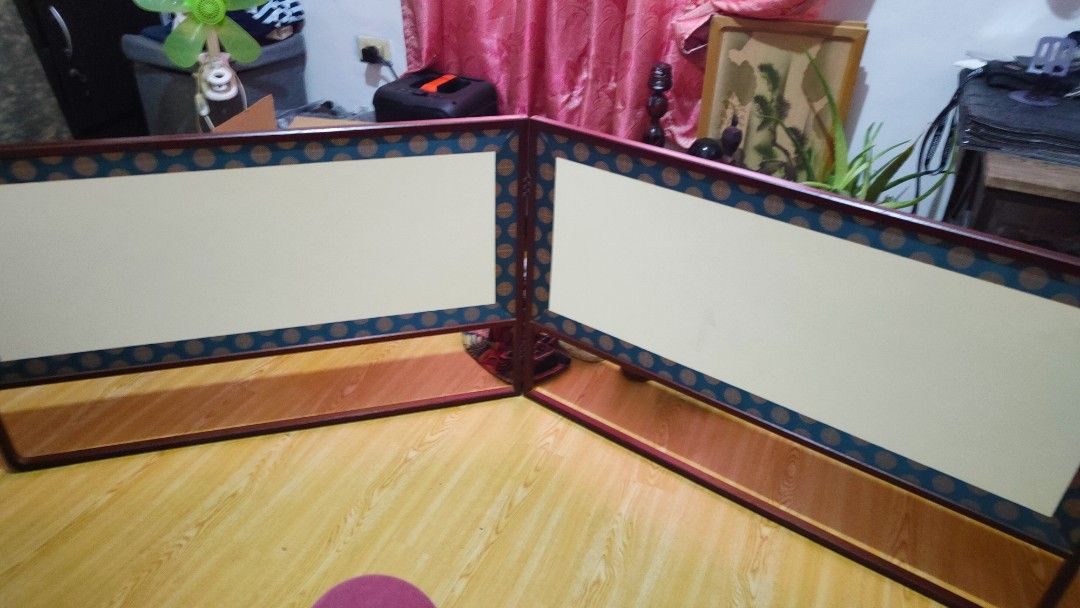 Wooden Room Divider Screen with Decorative Border (Category: Other Home Furniture) located in Manila. Submitted by joanngoter49528 (Listing ID 1442236204, Image 2). Description: - Dark wood folding room divider - Dual-sided panels: one woven texture, one plain - Decorative patterned border on panels - Ideal for dividing spaces - Folds easily for convenient storage size: height 21 inch, width 68 inc.