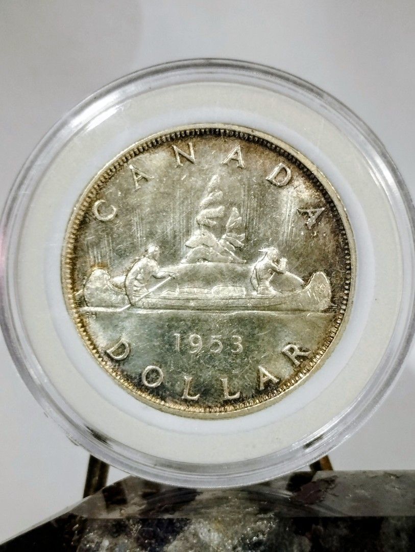 1953 Canada Silver Dollar Coin (Category: Currency) located in Quezon City. Submitted by pureblood_134 (Listing ID 1442418233, Image 1). Description: Selling a 1953 Canadian silver dollar coin. Features Queen Elizabeth II on one side and a canoe scene on the other. Made of.800 silver. Great addition to any coin collection. AU to Unc condition with luster and slight toning..