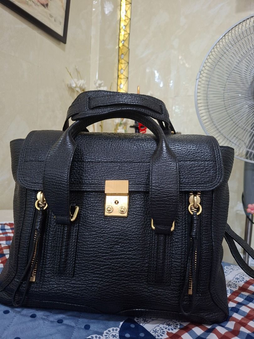 3.1 Phillip Lim Pashli Satchel (Category: Luxury Bags & Wallets) located in Rizal. Submitted by dims05 (Listing ID 1442373844, Image 3). Description: 3.1 Phillip Lim Pashli Medium Satchel – Black Selling my preloved 3.1 Phillip Lim Pashli Medium Satchel in classic black pebbled leather with gold-tone hardware. A timeless and versatile bag that's perfect for work, travel, or everyday use.Features the signature front flap lock closure, dual top han