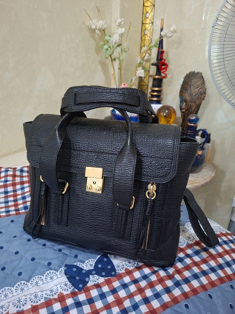 3.1 Phillip Lim Pashli Satchel (Category: Luxury Bags & Wallets) located in Rizal. Submitted by dims05 (Listing ID 1442373844, Image 2). Description: 3.1 Phillip Lim Pashli Medium Satchel – Black Selling my preloved 3.1 Phillip Lim Pashli Medium Satchel in classic black pebbled leather with gold-tone hardware. A timeless and versatile bag that's perfect for work, travel, or everyday use.Features the signature front flap lock closure, dual top han