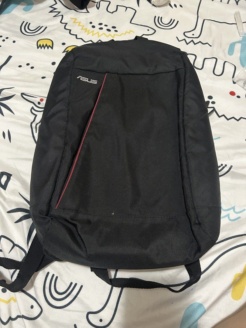 ASUS Black Laptop Backpack (Category: Backpacks) located in Paranaque City. Submitted by allthatclutterph (Listing ID 1442505553, Image 1). Description: - Stylish black ASUS backpack - Features a front zip pocket with eye-catching red trim - Adjustable straps for a comfortable fit - Multiple internal compartments for organized storage - Durable zippers with distinct ASUS branding - Ideal for carrying your laptop and daily essentials - Seldom used