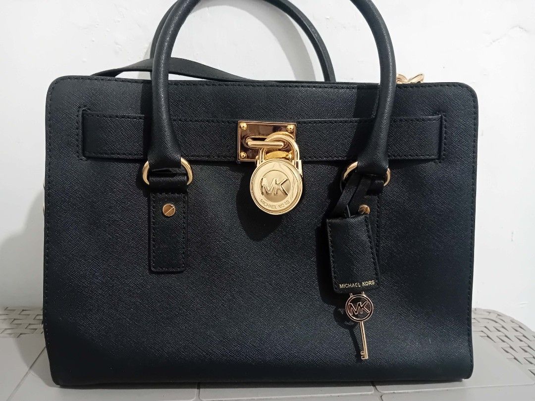 Authentic Michael Kors Hamilton Bag (Category: Luxury Bags & Wallets) located in Lipa City. Submitted by angelita.donut (Listing ID 1442534720, Image 1). Description: Reason for selling: never really used, just kept in the corner of my room collecting dust. I want it to go to someone who can actually put it to good use. Issue/s: • Dusty from storage • Minor discoloration/tarnishing on some gold hardware (chain links and lock area) • White powder 