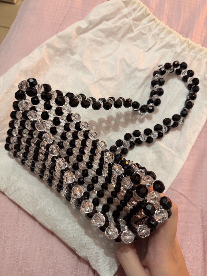 Black and Clear Beaded Shoulder Bag (Category: Shoulder Bags) located in Manila. Submitted by deklutterph (Listing ID 1442481830, Image 2). Description: - Cute beaded shoulder bag - Black and clear bead combination - Unique, eye-catching pattern - Ideal for going out or special occasions - Fits your essentials (phone, wallet, keys, etc.) - Includes a dust bag for storage.
