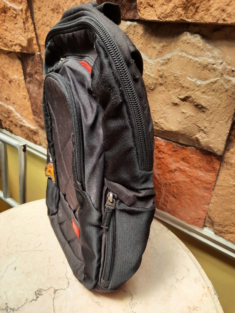 Black Backpack with Red Accents (Category: Backpacks) located in Bulacan. Submitted by nice.finds (Listing ID 1442387902, Image 3). Description: - Chic black backpack with a trendy quilted front panel. - Eye-catching red trim on zippers and straps for a pop of color. - Multiple interior compartments to keep your essentials organized. - Comfortable padded shoulder straps for easy carrying. - Comes with a cute keychain attached, adding a personal t