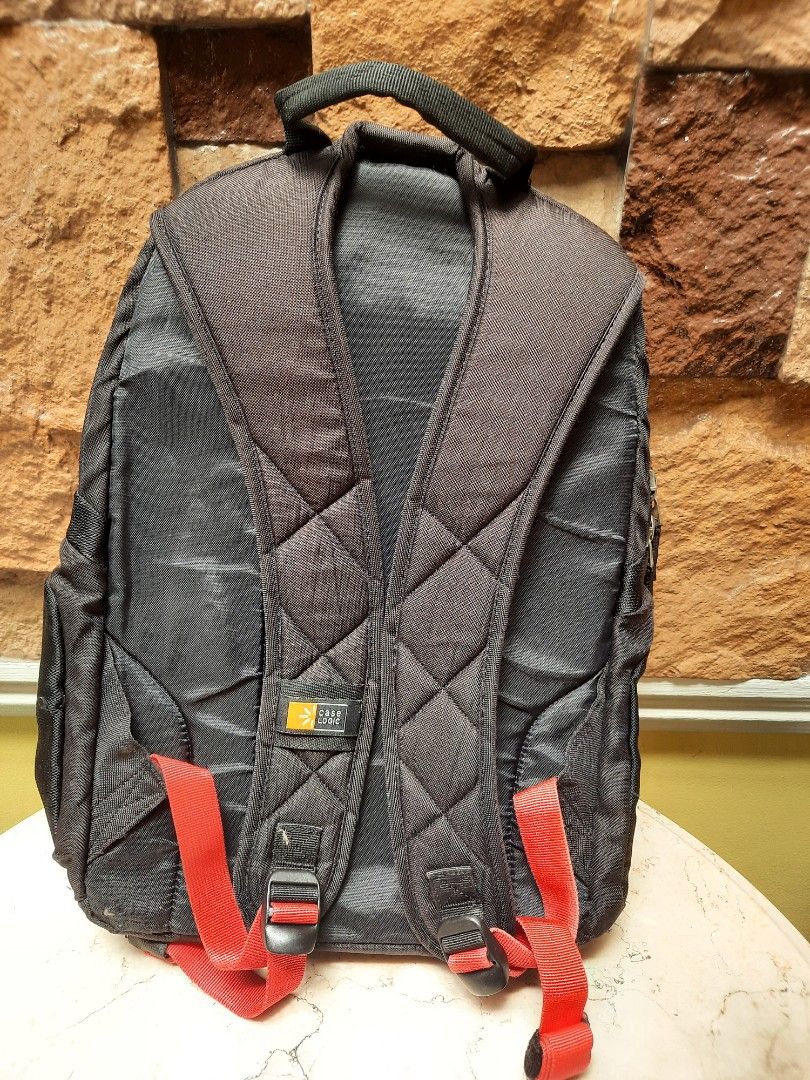 Black Backpack with Red Accents (Category: Backpacks) located in Bulacan. Submitted by nice.finds (Listing ID 1442387902, Image 2). Description: - Chic black backpack with a trendy quilted front panel. - Eye-catching red trim on zippers and straps for a pop of color. - Multiple interior compartments to keep your essentials organized. - Comfortable padded shoulder straps for easy carrying. - Comes with a cute keychain attached, adding a personal t