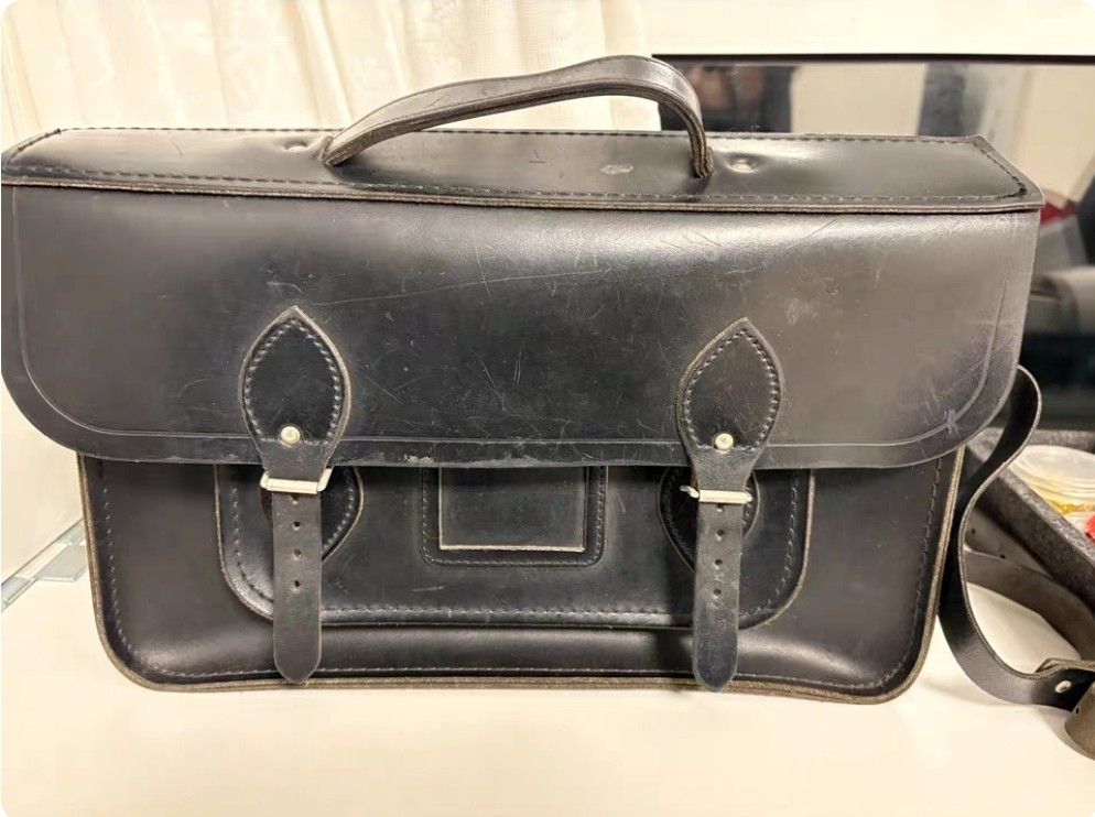 Black Leather Satchel Bag with Buckle Closures (Category: Luxury Bags & Wallets) located in Quezon City. Submitted by viflor (Listing ID 1442373128, Image 1). Description: Vintage Cow leather Solid 13 inches Sign of usage Classic black leather satchel bag - Features a top handle - Adjustable buckle straps for closure - Structured design with a front flap - Versatile for everyday use or as a statement piece.