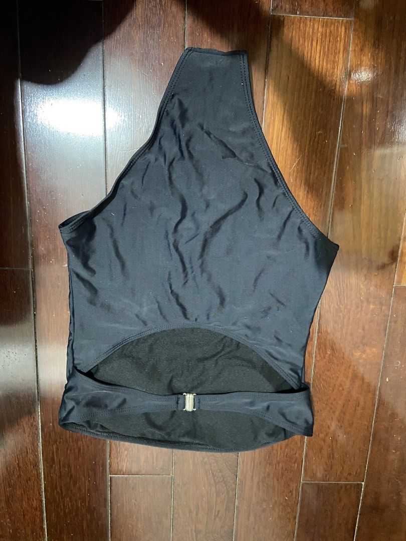 Black One-Piece Swimsuit (Category: Bikinis & Swimsuits) located in Valenzuela. Submitted by decluttermaniac (Listing ID 1442523298, Image 2). Description: - Sleek black one-piece swimsuit - Flattering high-cut leg design - Trendy one-shoulder strap - Chic waist cut-out detail - Secure metal clasp closure at the back - Size: Medium (M) - Ideal for beach and pool outings.