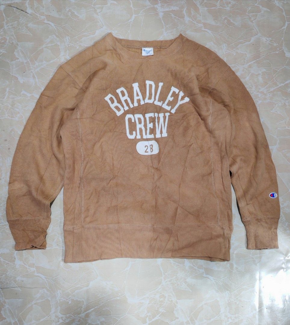 Champion Reverse Weave Crewneck Sweatshirt - Tan - Large (Category: Coats, Jackets and Outerwear) located in Cotabato. Submitted by rayhan.thriftee (Listing ID 1442369872, Image 1). Description: - Champion Reverse Weave Sweatshirt - Color: Tan - Graphic: 'BRADLEY CREW' on front - Size: Large (tag) - Material: 90% Cotton, 10% Polyester - Made in China - Ideal for casual wear.