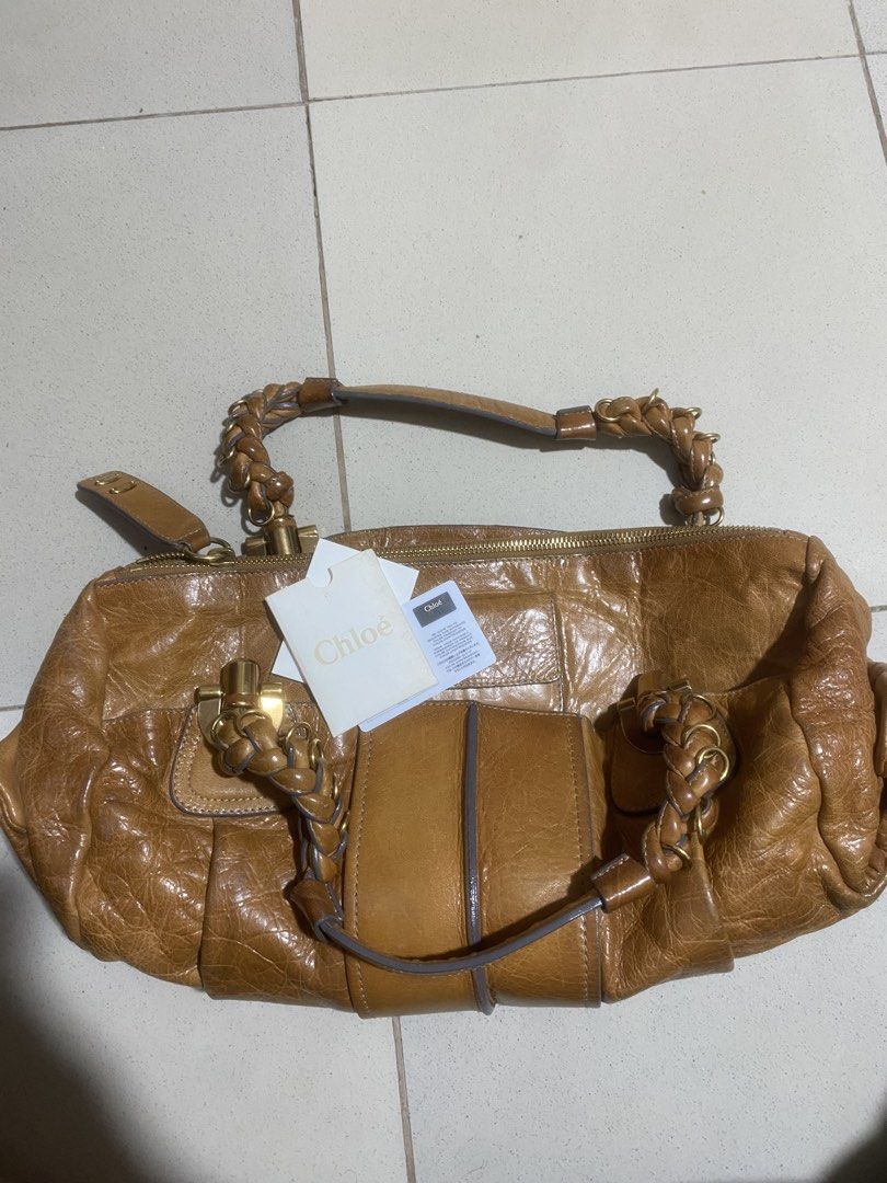 Chloe Heloise Satchel Bag (Category: Luxury Bags & Wallets) located in San Mateo. Submitted by a11yl (Listing ID 1442517607, Image 1). Description: Preloved bought from japan - Authentic Chloe bag - Color: Tan brown leather - Features: Braided handles, gold hardware, zipper closure - Interior: Pocket with serial number 02 08 58 - Includes: Authenticity card and tag.