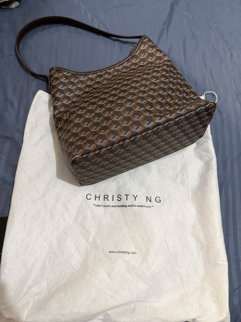 Christy Ng Monogram Shoulder Bag with Dust Bag (Category: Luxury Bags & Wallets) located in Caloocan City. Submitted by mimeeo (Listing ID 1442441634, Image 1). Description: - Authentic Christy Ng Alesso Hobo Bag - Features signature monogram pattern - Chestnut brown and grey color combination - Interior zippered pocket for secure storage - Comes with original dust bag - Ideal for everyday wear and tear.