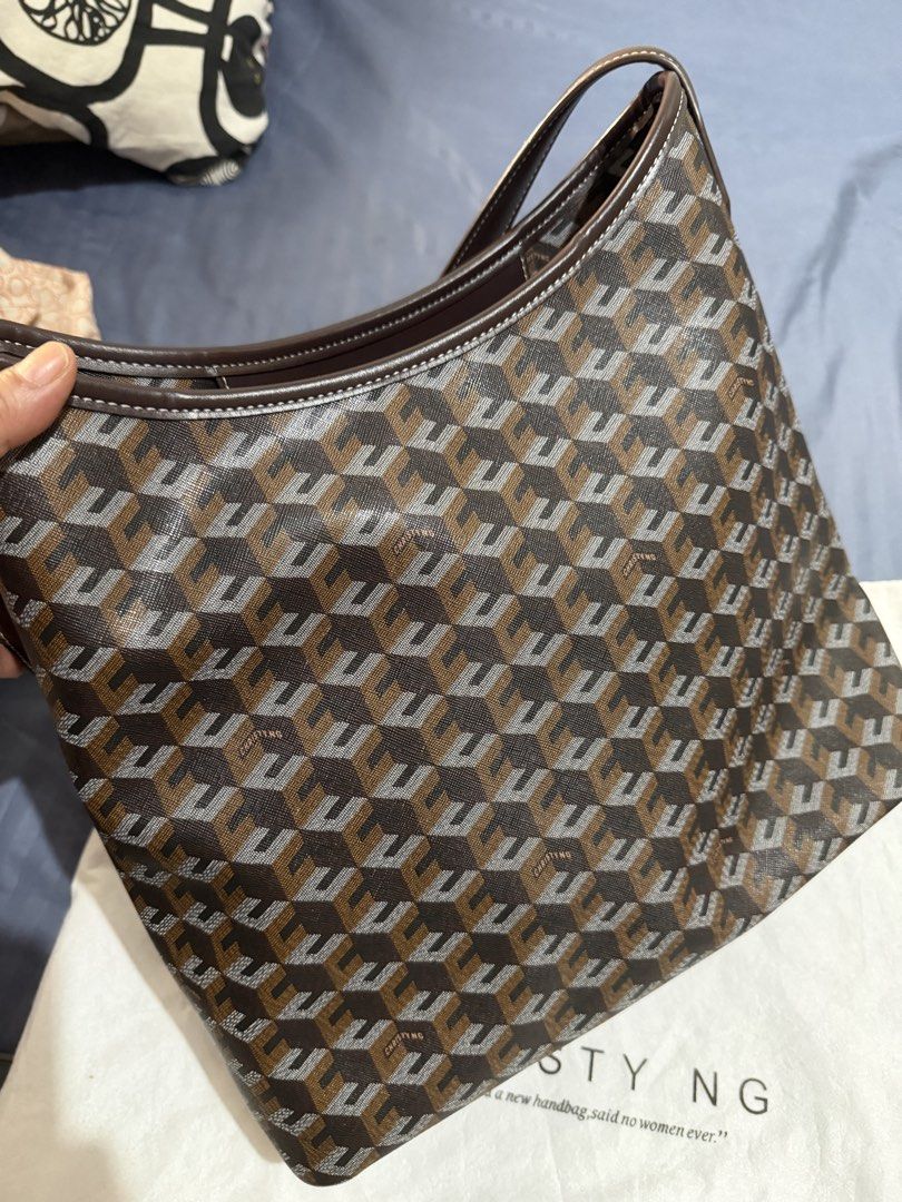 Christy Ng Monogram Shoulder Bag with Dust Bag (Category: Luxury Bags & Wallets) located in Caloocan City. Submitted by mimeeo (Listing ID 1442441634, Image 3). Description: - Authentic Christy Ng Alesso Hobo Bag - Features signature monogram pattern - Chestnut brown and grey color combination - Interior zippered pocket for secure storage - Comes with original dust bag - Ideal for everyday wear and tear.