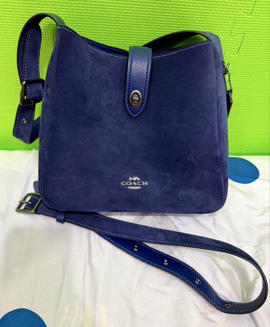 Coach Hadley Convertible in True Navy Suede (Category: Luxury Bags & Wallets) located in Las Pinas. Submitted by djcarla14 (Listing ID 1442468550, Image 1). Description: Flaws: • Signs of wear, which are normal for suede material bags • Lipstick stain • Marks on the turn lock hardware Features: • Convertible straps (can be worn as crossbody) • US bought Inclusions: • Complete with care card Usage: • Used thrice only DM FOR MORE PICS.
