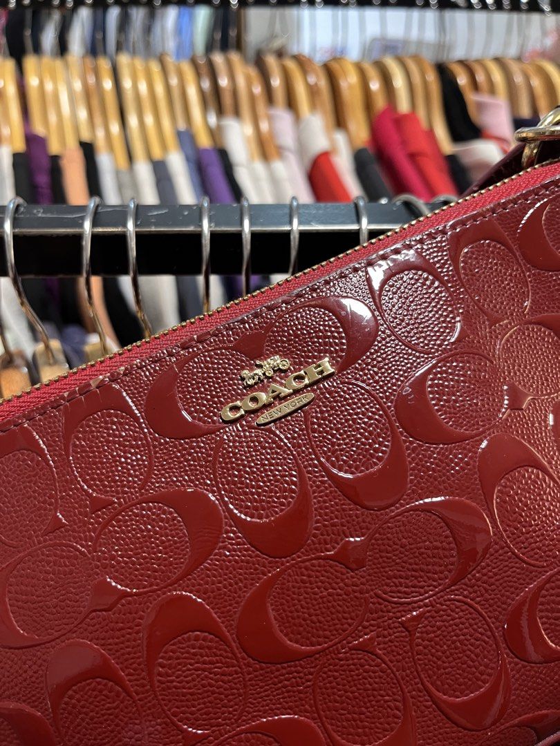 Coach Monogram Embossed Leather Shoulder Bag (Category: Luxury Bags & Wallets) located in Davao. Submitted by 4mscllection (Listing ID 1442405271, Image 2). Description: - Authentic Coach shoulder bag - Deep red color with all-over embossed monogram pattern - Gold hardware and zipper closure - Interior Coach creed tag and serial number - Small and compact, ideal for essentials - Versatile for night outs or casual use.