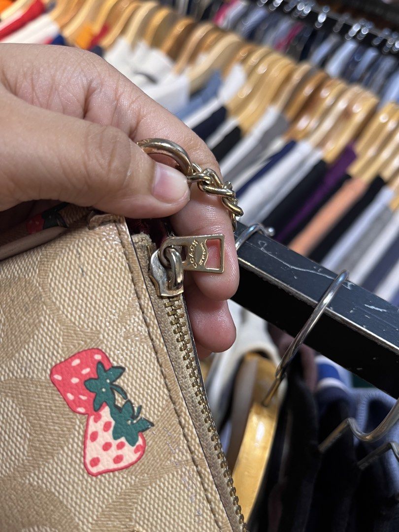 Coach Monogram Strawberry Print Mini Bag with Chain (Category: Luxury Bags & Wallets) located in Davao. Submitted by 4mscllection (Listing ID 1442405398, Image 3). Description: - Cute Coach mini bag - Classic monogram print with fun strawberry design - Gold chain strap - Zipper closure - Ideal for carrying essentials - Small and compact.