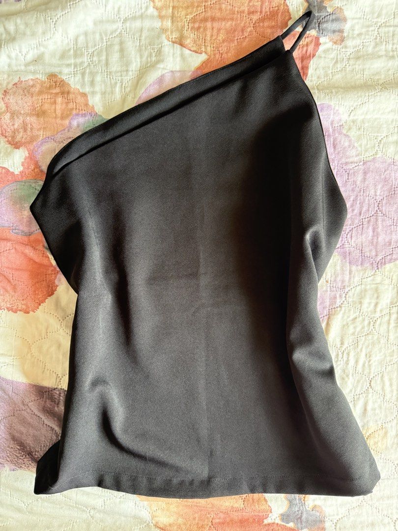 Custom Black One Shoulder Camisole Top (Category: Sleeveless) located in Taguig. Submitted by lovedby_flora (Listing ID 1442526988, Image 1). Description: ‼️ LAST PRICE POSTED‼️ - NO WHEN WORN - Elegant satin-like black camisole top - Stylish one-shoulder design with a thin strap - Fabric boasts a beautiful sheen - Perfect for dressing up or down.