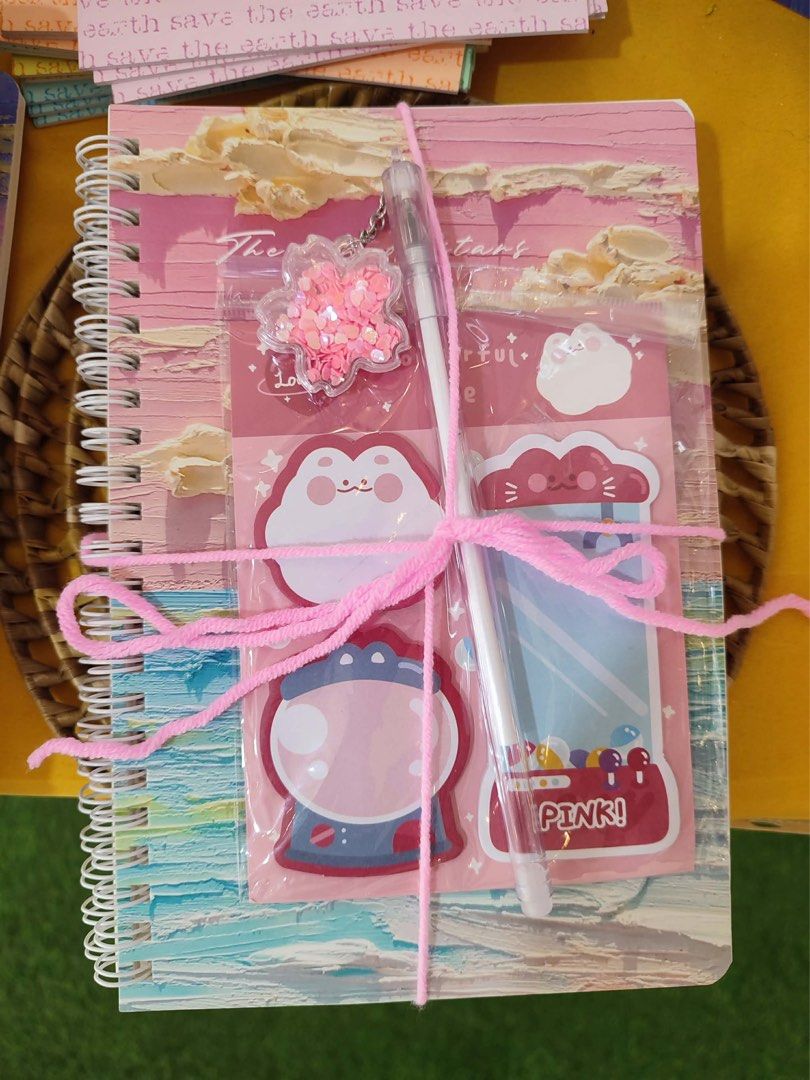 Cute Pink Stationery Set with Notebook and Pen (Category: Stationery & School Supplies) located in Marikina City. Submitted by jennyggg25 (Listing ID 1442422863, Image 1). Description: - Adorable stationery set - Spiral notebook with pink sky design - Includes a pen - Features cloud and character sticky notes - Comes with a sparkly star keychain - Secured with a pink yarn tie - Ideal for journaling or as a gift.