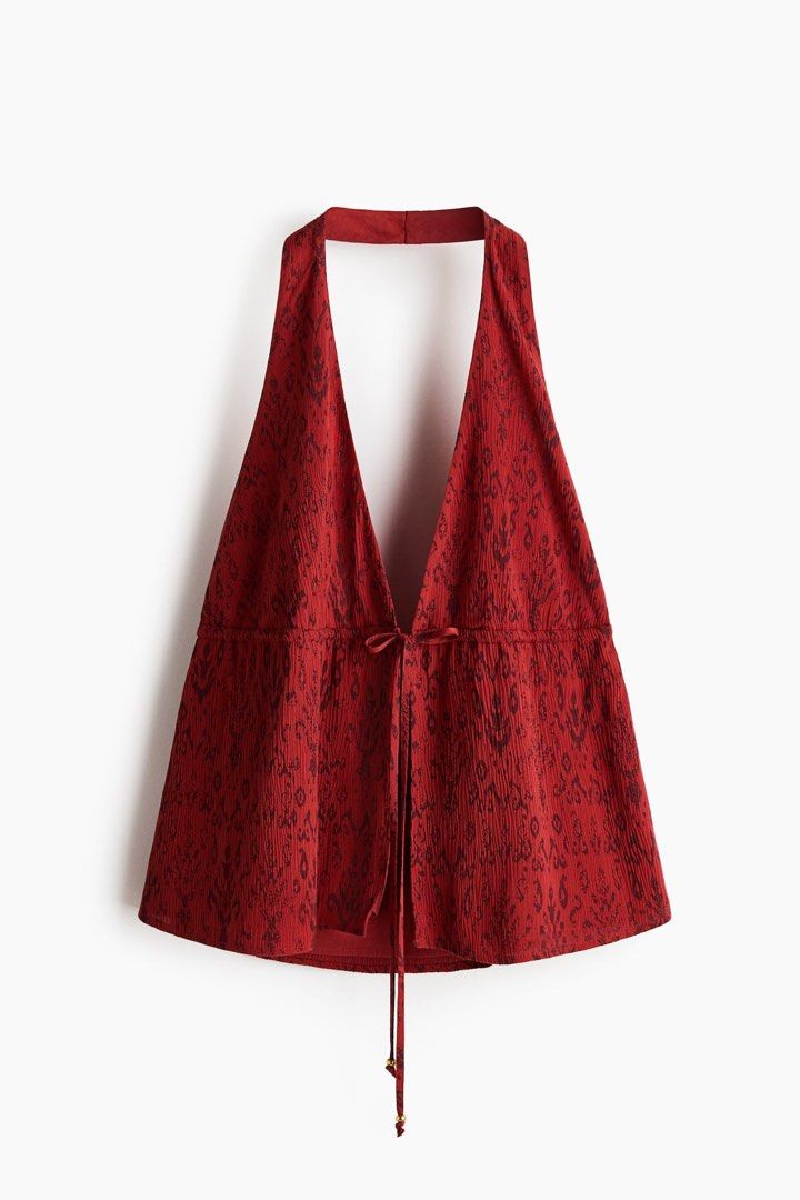 Halter neck top (Category: Sleeveless) located in Manila. Submitted by paperthread (Listing ID 1442443947, Image 1). Description: - Red halter neck top - Features a tribal print - Ties at the front with a drawstring - Peplum hem - Open back design - Versatile: pairs well with shorts or jeans - Ideal for summer outings or beach vacations Actual color is red orange, actual item is on the last photo. .