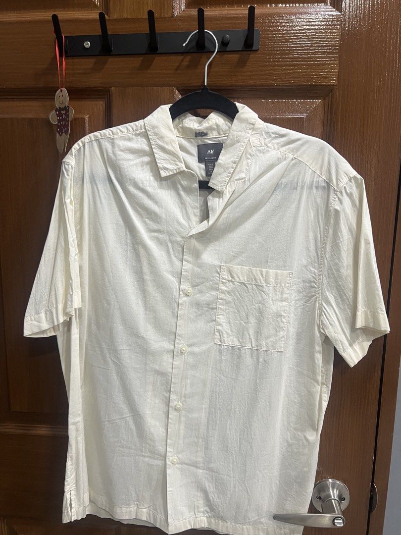 H&M Regular Fit Short Sleeve Shirt (Category: Tshirts & Polo Shirts ) located in Quezon City. Submitted by goodstuffsssssph (Listing ID 1442386272, Image 1). Description: - Cream colored short sleeve button-up shirt - Brand: H&M - Fit: Regular - Features: Chest pocket - Condition: Minor faint marks on collar area (please check photos for details).