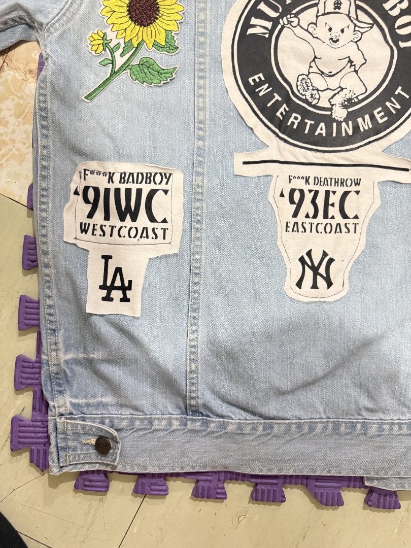 JAG Authentic Classic Denim Jacket with Patches Size L (Category: Coats, Jackets and Outerwear) located in Manila. Submitted by its.thrifted (Listing ID 1442526166, Image 3). Description: - JAG light wash denim jacket - Size: Large (L) - Unique custom patches on the back: 'MUMMA'S BOY ENTERTAINMENT', New York Yankees, Los Angeles Dodgers, sunflower, and more graphics. - Classic button-up front - Two chest pockets - Perfect statement piece to elev