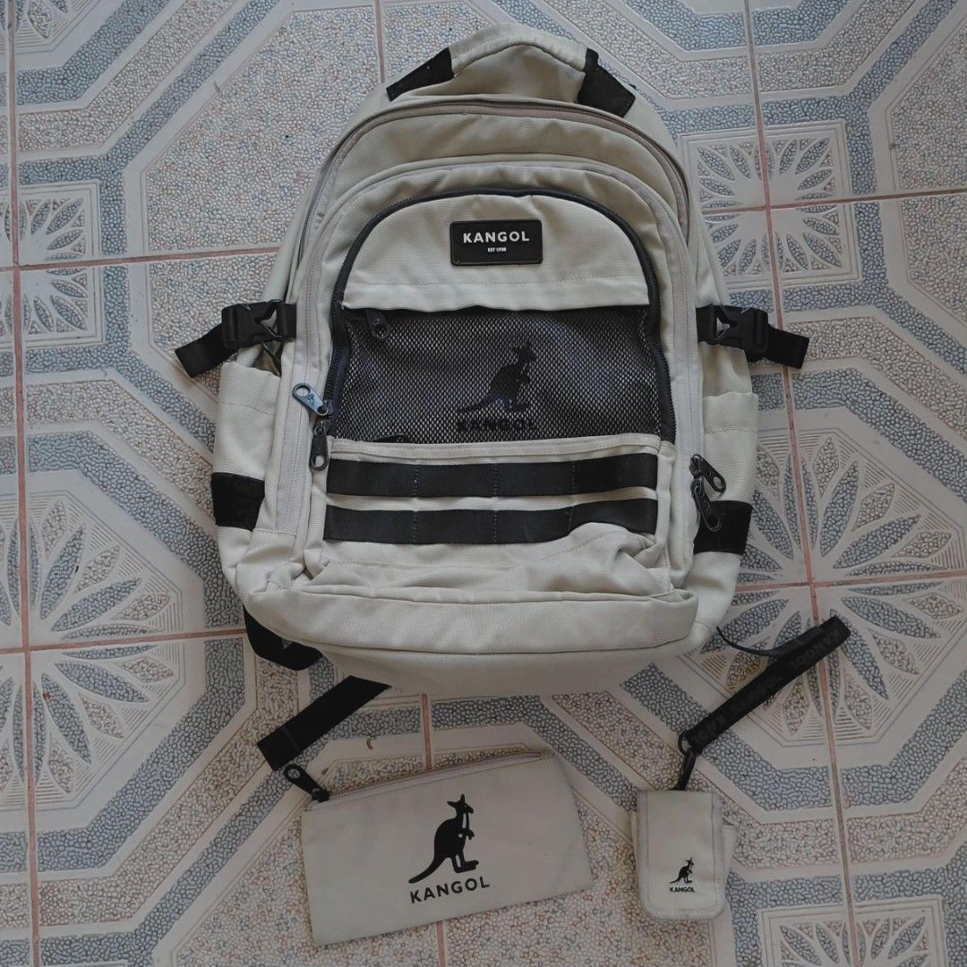 Kangol Backpack with Pouch and Small Bag (Category: Backpacks) located in Danao, Cebu. Submitted by thriftmini88932 (Listing ID 1442374069, Image 1). Description: - Beige Kangol backpack - Multiple compartments for organization - Stylish mesh detailing - Includes matching pouch - Comes with a small hanging bag - Adjustable straps for comfort - Ideal for school or everyday use.