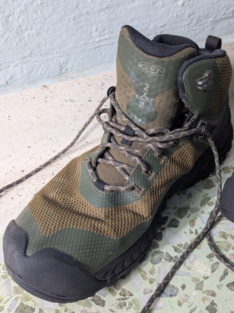 KEEN NXIS Waterproof Hiking Boots - Men's Size 9 (Category: Boots) located in Singapore. Submitted by ozz (Listing ID 1442419586, Image 3). Description: - KEEN NXIS hiking boots - Mid-height for excellent ankle support - Waterproof construction to keep feet dry - Stylish green and brown camouflage pattern - Perfect for trails and outdoor adventures - Laces included - purchased in 2022 - done not more than 130kms - Get ready for your next hike! - 