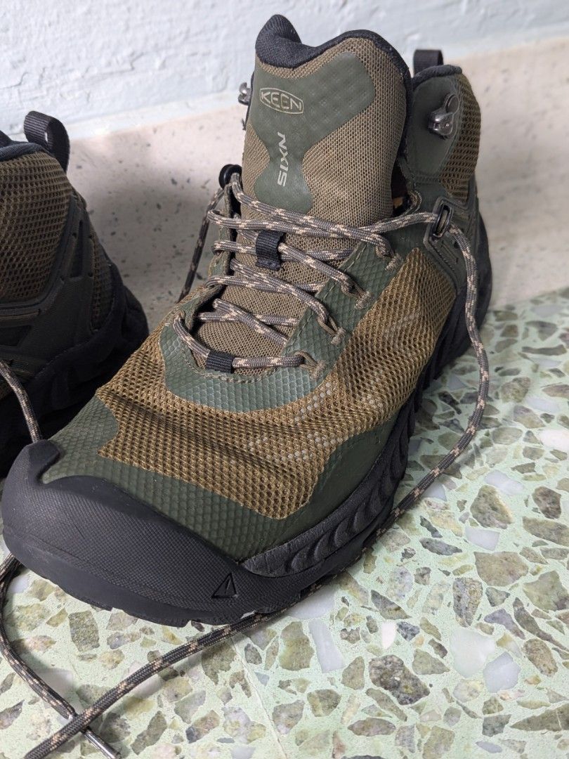 KEEN NXIS Waterproof Hiking Boots - Men's Size 9 (Category: Boots) located in Singapore. Submitted by ozz (Listing ID 1442419586, Image 2). Description: - KEEN NXIS hiking boots - Mid-height for excellent ankle support - Waterproof construction to keep feet dry - Stylish green and brown camouflage pattern - Perfect for trails and outdoor adventures - Laces included - purchased in 2022 - done not more than 130kms - Get ready for your next hike! - 