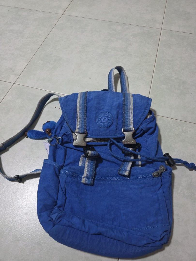 Kipling Blue Backpack (Category: Backpacks) located in Singapore. Submitted by hanbee (Listing ID 1442404939, Image 1). Description: - Blue Kipling backpack - Multiple pockets and zippers for organization - Adjustable straps for comfortable wear - Durable nylon material - Ideal for everyday use or travel - Comes with the classic Kipling monkey charm.