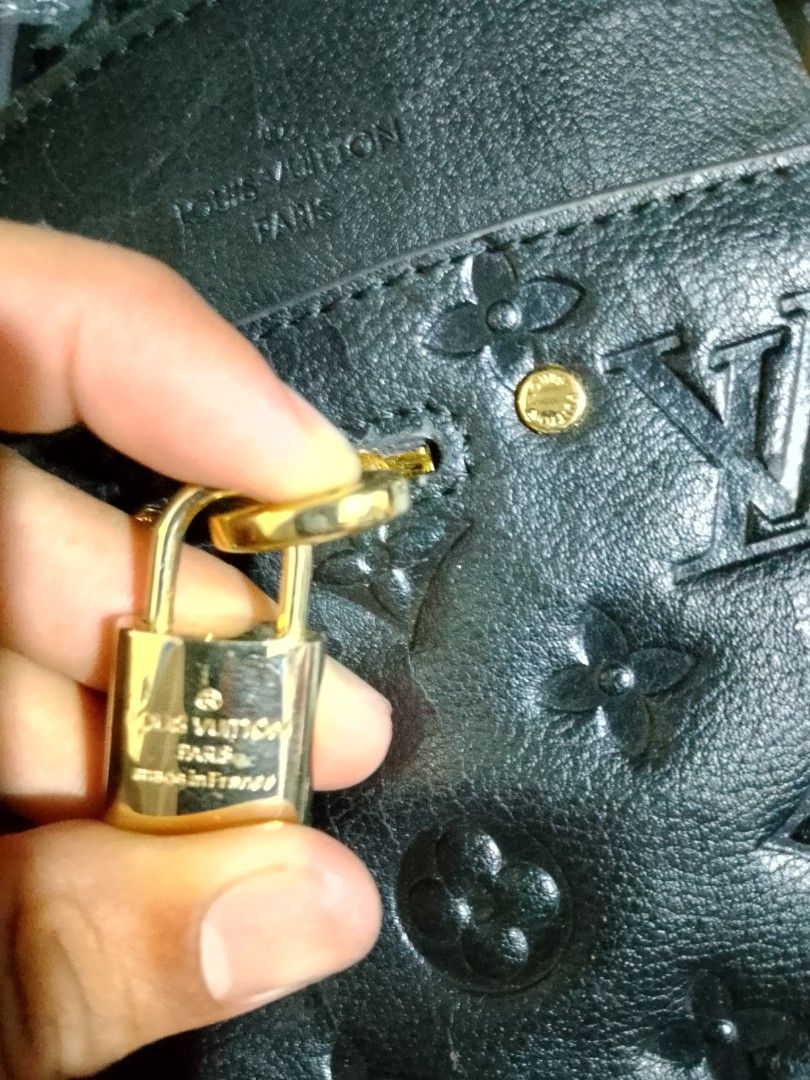 Louis Vuitton Black Monogram Embossed Handbag with Lock (Category: Luxury Bags & Wallets) located in Iloilo. Submitted by janillthrifted (Listing ID 1442482152, Image 2). Description: - Authentic Louis Vuitton handbag - Classic Monogram pattern - Gold hardware details - Zipper closure - Includes small padlock and key - Made in France - Ideal for everyday use.