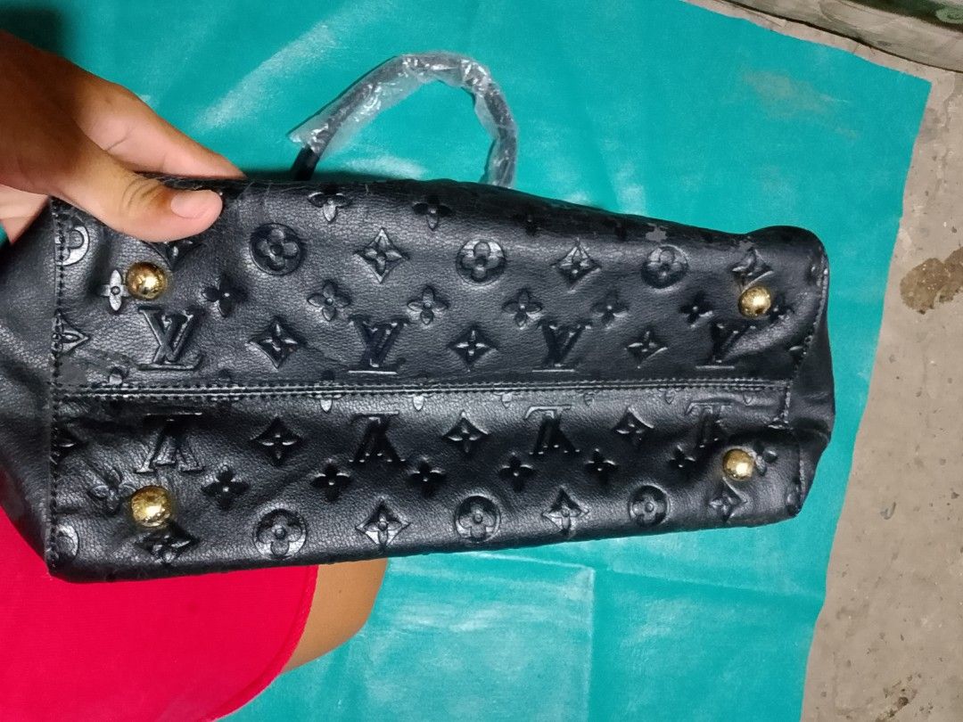 Louis Vuitton Black Monogram Embossed Handbag with Lock (Category: Luxury Bags & Wallets) located in Iloilo. Submitted by janillthrifted (Listing ID 1442482152, Image 3). Description: - Authentic Louis Vuitton handbag - Classic Monogram pattern - Gold hardware details - Zipper closure - Includes small padlock and key - Made in France - Ideal for everyday use.