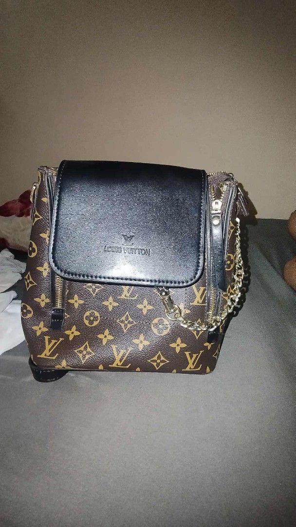 Louis Vuitton Monogram Backpack (Category: Luxury Bags & Wallets) located in Manila. Submitted by turlajhone67988 (Listing ID 1442389262, Image 1). Description: - Authentic Louis Vuitton monogram backpack in brown. - Features a chic black leather flap with the iconic LV logo. - Elegant gold chain detailing on the sides. - Convenient front zipper pocket for easy access. - Ideal for daily use, carrying all your essentials in style..