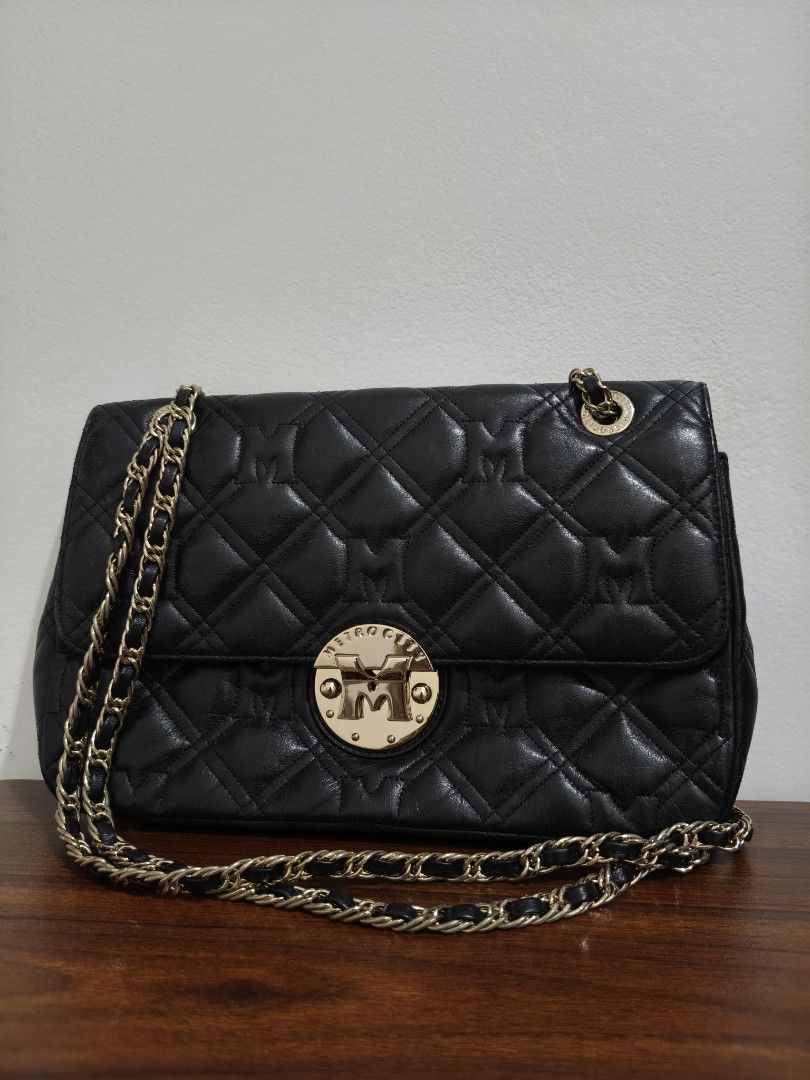 METROCITY Black Quilted Leather Chain Shoulder Bag (Category: Shoulder Bags) located in Manila. Submitted by bmsthrift (Listing ID 1442452410, Image 1). Description: - Brand: METROCITY - Material: Black quilted leather - Strap: Gold chain shoulder strap - Closure: Zipper - Details: Signature 'M' logo on front closure and interior tag - Style: Versatile for everyday use or evening events.