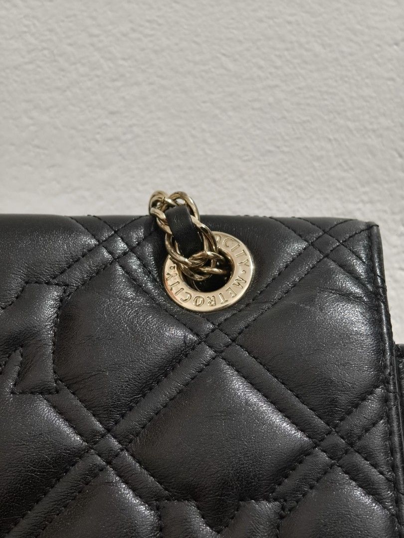 METROCITY Black Quilted Leather Chain Shoulder Bag (Category: Shoulder Bags) located in Manila. Submitted by bmsthrift (Listing ID 1442452410, Image 3). Description: - Brand: METROCITY - Material: Black quilted leather - Strap: Gold chain shoulder strap - Closure: Zipper - Details: Signature 'M' logo on front closure and interior tag - Style: Versatile for everyday use or evening events.