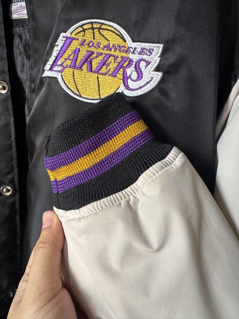 Mitchell & Ness Los Angeles Lakers Hardwood Classics Jacket (Category: Coats, Jackets and Outerwear) located in Manila. Submitted by cvpeb (Listing ID 1442403305, Image 3). Description: - Classic Los Angeles Lakers satin bomber jacket - Features iconic Lakers logo on the chest - Ribbed cuffs and collar with purple and gold stripes - Quilted lining for added warmth - Easy snap button closure - A must-have for any Lakers fan!.
